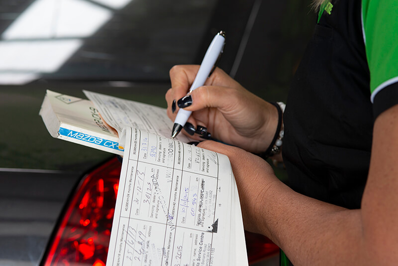 Noranda Service Centre Services - Logbook Servicing - Car Staff Booking a Vehicle Service Checking Logbook